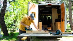 Man customizing his handcrafted camper van