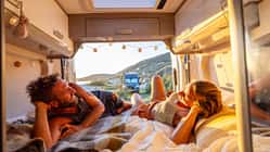 Cozy Couple Watching Sunset from Camper Van