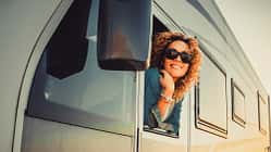 Portrait Of Young Woman Leaning Outside Van