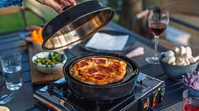Omnia Stovetop Pizza Oven in Benutzung draußen beim Camping