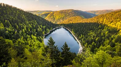 Aerial view of the glacial lake "Lac des Corbeaux" at sunset, Vosges mountains, Lorraine, France. Aerial view of the glacial lake "Lac des Corbeaux" at sunset, Vosges mountains, Lorraine, France.