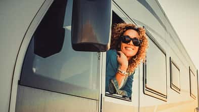 Portrait Of Young Woman Leaning Outside Van