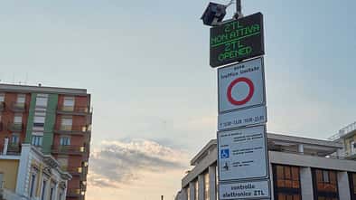 signboard,traffic control,nurphoto,ztl,urban area,vehicle passage,zona a traffico limitato,traffic management,vehicle entry,july 18,temporary suspension,road access,regulations suspended,not active,urban traffic,traffic sign,traffic zone,city center,city traffic,electronic display,public notice.,traffic regulations,restricted traffic zone,traffic notice,driving regulations,matteo della torre,vehicle access,italian city,access allowed ZTL Not Active - Digital Sign In Italian Urban Area