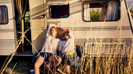 Mother with daughter relaxing at a caravan Mother with daughter relaxing at a caravan