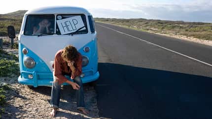 Young couple with broken down van on roadside