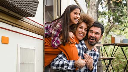 Mom dad and daughter mixed-race family driving van home on wheels camper together. Adventure on caravanning. Road trip voyage with children kids Mom dad and daughter mixed-race family driving van home on wheels camper together. Adventure on caravanning. Road trip voyage with children kids