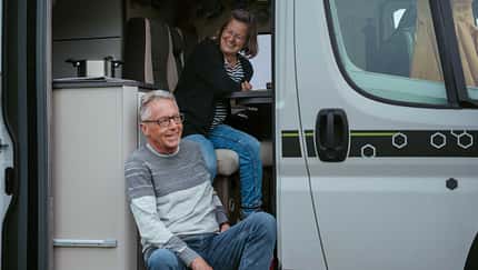Mature couple looking outside camper van