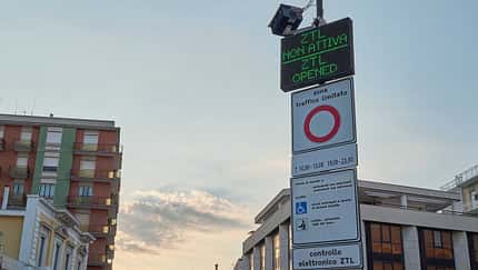 signboard,traffic control,nurphoto,ztl,urban area,vehicle passage,zona a traffico limitato,traffic management,vehicle entry,july 18,temporary suspension,road access,regulations suspended,not active,urban traffic,traffic sign,traffic zone,city center,city traffic,electronic display,public notice.,traffic regulations,restricted traffic zone,traffic notice,driving regulations,matteo della torre,vehicle access,italian city,access allowed ZTL Not Active - Digital Sign In Italian Urban Area