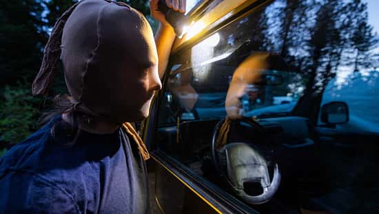 Masked Intruder Peering into Car at Night
