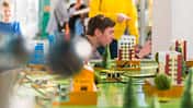 Teenagers, boy, and girl, exploring electronic equipment on the exhibition of the Hall of Science and Technology