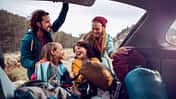 Young family getting the camping supplies out of the car