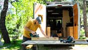 Man customizing his handcrafted camper van